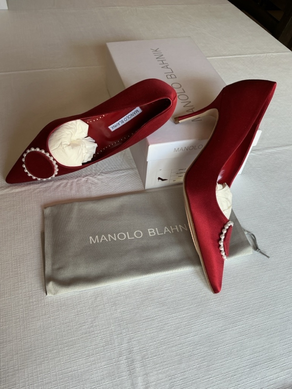 Manolo Blahnik KIFACLO Red Satin Pointed Pumps with Pearl-Embellished design.